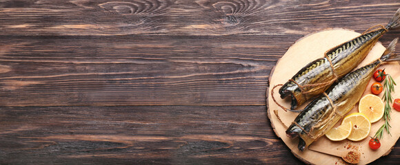 Board with tasty smoked mackerel fish on wooden background with space for text