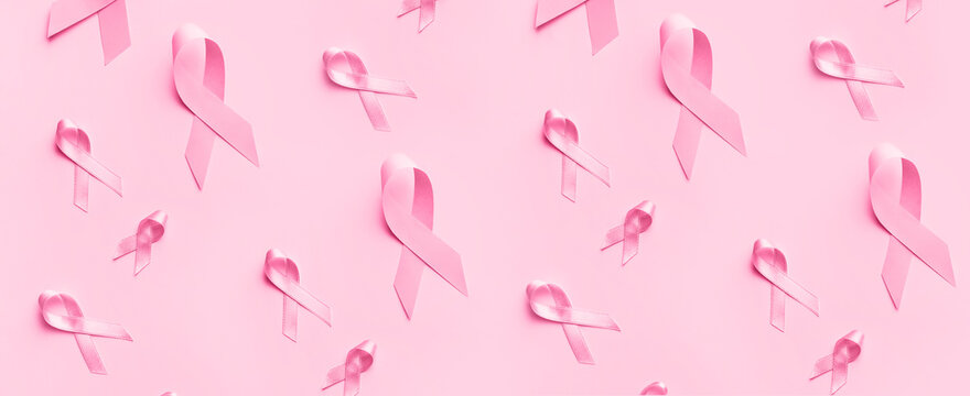 Many pink ribbons on color background. Breast cancer awareness concept