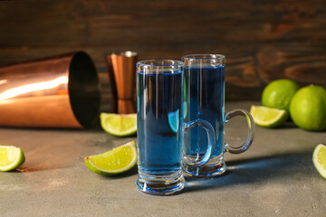 Shot cocktails and limes on table