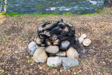 Abandoned extinct stone hearth for bonfire. Place of cooking of ancient people. Survival in wild. Protecting forest from spread of fire