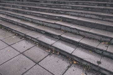 Stone wet steps after autumn rain. Yellow leaves and moisture. Pedestrian hazard, risk of injury to fall, safe urban environment