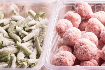 Containers with frozen  vegetables and semi-finished meat products  from the refrigerator. meatballs, chopped beans