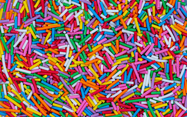 Fototapeta na wymiar Dots of sugar sprinkles, cake and pastry decoration, lots of sprinkles as a background