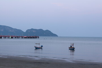 Thailand Beach wide view at dawn with small boat