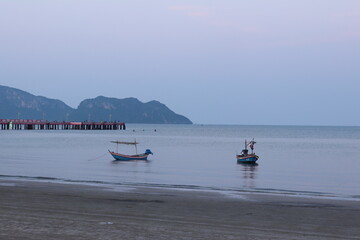 Thailand Beach wide view at dawn with small boat