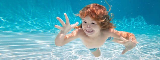 Child underwater. Funny face portrait of child boy swimming and diving underwater with fun in pool. Banner for header, copy space. Poster for web design. - obrazy, fototapety, plakaty