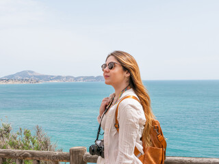 woman on the beach with a camera