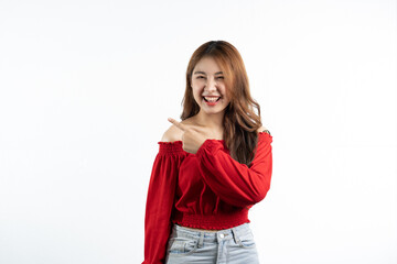 Young elegant beautiful Asian woman smiling and pointing to empty copy space isolated on white background.