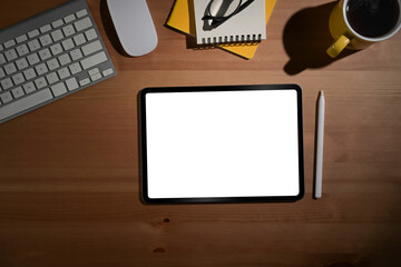 Digital tablet, stylus pen and supplies on wood background. Blank screen for advertising display...