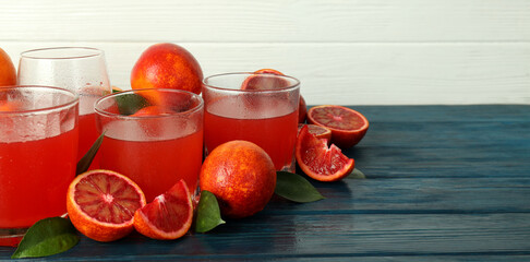 Concept of fresh drink with red orange juice, space for text