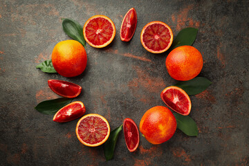Concept of citrus with red orange on textured background