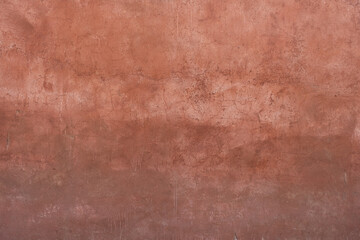 A stone wall with old paint of rough texture and cracks close-up. Background for designers.