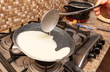 Pancakes from liquid dough are fried