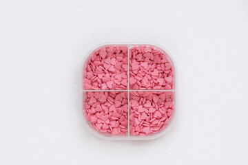 In the pill box, instead of pills, there are small pink hearts. The concept of treatment with love and warm relationships. Libido booster