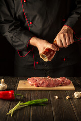 The chef prepares the veal meat and adds pepper or chili. Working environment in the kitchen during barbecue. Asian cuisine