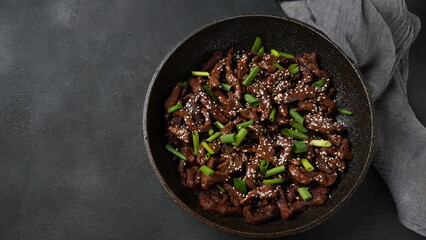 Mongolian meat - beef in dark spicy sauce in asian style