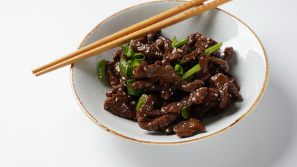 Mongolian meat - beef in dark spicy sauce in asian style