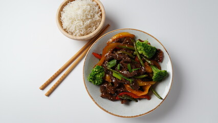 Mongolian meat in sauce with rice. Mongolian barbecue with meat and vegetables in Thai restaurant