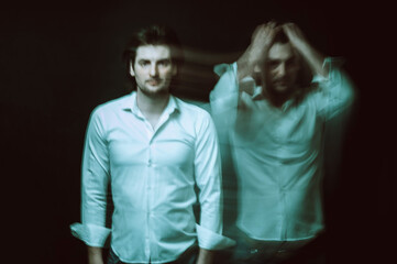 schizophrenic blurred portrait of psychopathic man with mental disorders and disorders on dark background