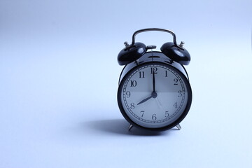 black vintage style alarm clock isolated on a white background
