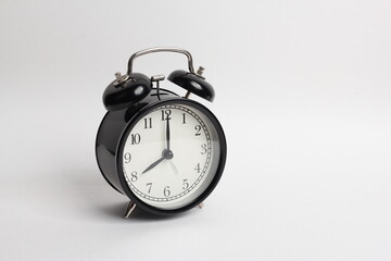 black vintage style alarm clock isolated on a white background