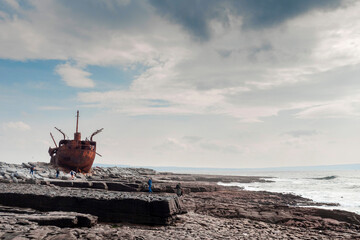 Plassey shipwreck on shore of Inisheer island. Aran islands, county Galway, Ireland. Rough stone...