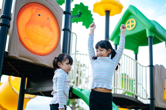 two girls playing in the playground.