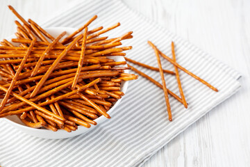 Crunchy Salty Baked Pretzel Sticks in a Bowl, low angle view. Space for text.