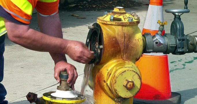 Utility worker repairs a fire hydrant, California, 4K
