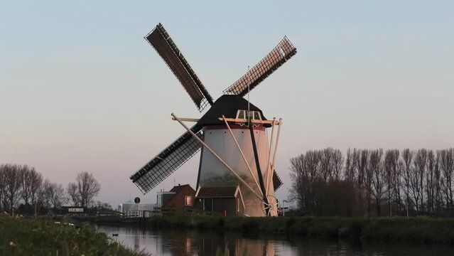 Dutch mill alongside small canal in Schipluiden, the Netherlands