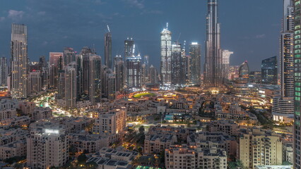 Naklejka na ściany i meble Dubai Downtown night to day timelapse with tallest skyscraper and other towers
