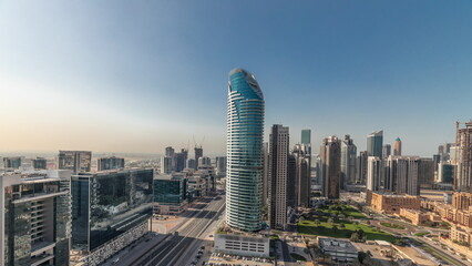 Obraz premium Panorama showing Dubai's business bay towers aerial morning timelapse. Rooftop view of some skyscrapers