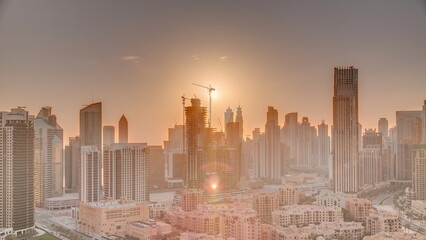 Dubai's business bay towers at sunset aerial timelapse. Rooftop view of some skyscrapers