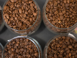 Lots of glass jars with coffee beans top view