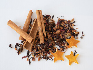 A set of ingredients for mulled wine is scattered on the table. Cinnamon sticks, dried star-shaped orange, anise