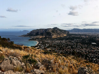 Fototapeta na wymiar Mondello, Sicily, panoramic view of the town from the Capo Gallo Reserve with Mount Pellegrino on and the promontory of Cefalù in the distance