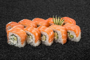 Sushi with red fish, Asian cuisine. Photo of food on a dark background