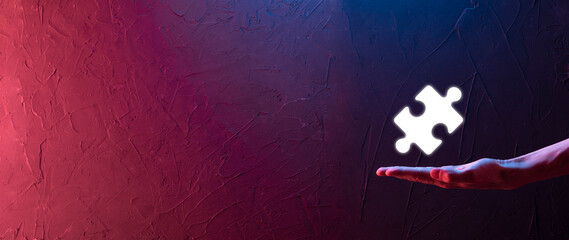 Businessman hands connecting puzzle pieces representing the merging of two companies or joint...