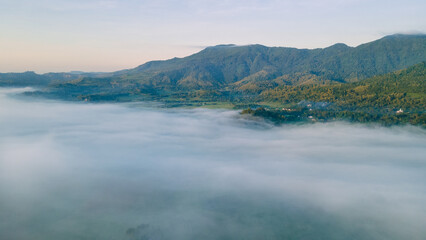 Naklejka na ściany i meble Aerial view, sea of fog covering the village in the morning