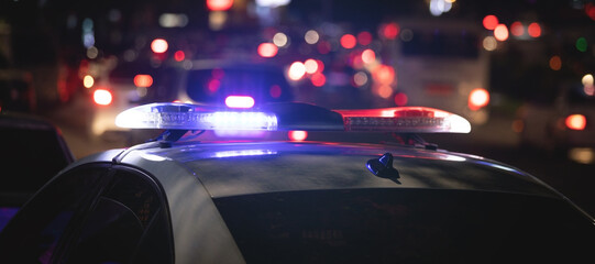 Red and blue light flasher. Police car at night time in the city