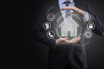 Businessman hold house icon.Smart home controlled, intelligent house, and home automation app concept.Pcb design and person with smart phone. Innovation technology internet Network Concept.