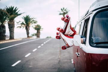 Travel and freedom concept with classic skate and van with long asphalt straight road in background. Old lifestyle alternative trendy. Red color. People traveling and enjoying leisure on the road