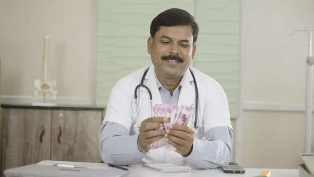 happy smiling doctor couting money at hospital - concept of earning, success, and professional occupation