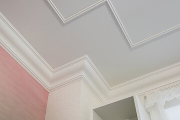 Detail of corner ceiling cornice with intricate crown molding. - obrazy, fototapety, plakaty