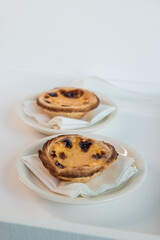 Pastel de Nata, a traditional sweet from Portuguese cuisine. Small crunchy puff pastry pies and a cream made with eggs. Often tasted and accompanied with coffee. Top view