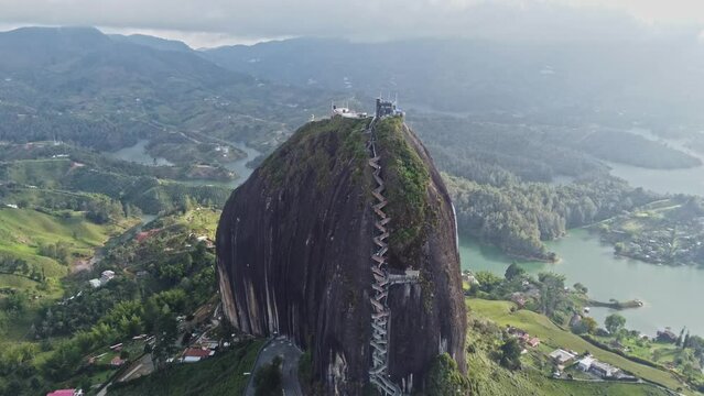 Aerial View Of Piedra del peñol monolith big black stone in Guatape, Antioquia - Colombia tourist site - drone shot