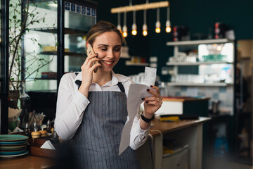 waitress is working in restaurant. checking paper work