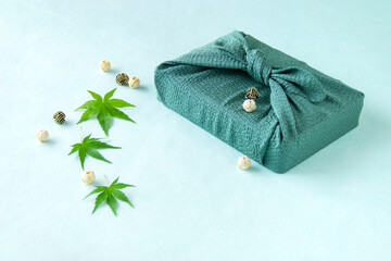 緑のモミジと水引玉と風呂敷包みのデザイン（ブルーバック）
