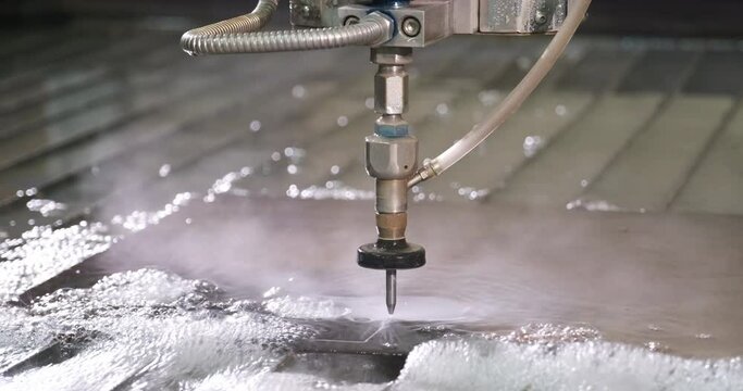 Waterjet high pressure CNC machine is cutting out a holes on a metal sheet. Modern technologies in industries, manufacturing and metallurgy. Hydro abrasive metal cutting. 