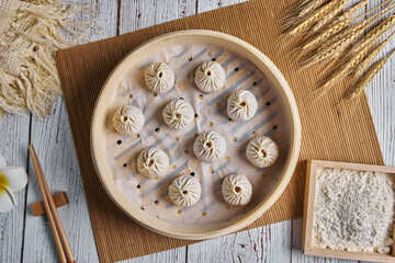 Chinese Buns or Xiaolongbao with crab meat and roe in bamboo basket. Ready for steam.